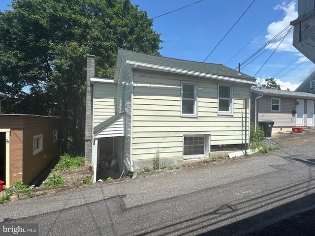 219 E Pike St, Bellefonte, PA 16823 - view of side of home featuring a chimney and roof with shingles