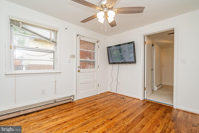 1916 Porter Ave, Suitland, MD 20746 - spare room with a baseboard heating unit, wood finished floors, and a ceiling fan