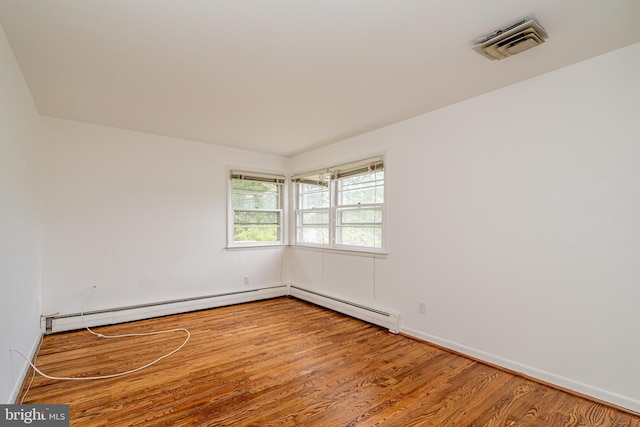 1916 Porter Ave, Suitland, MD 20746 - unfurnished room featuring wood finished floors and a baseboard radiator
