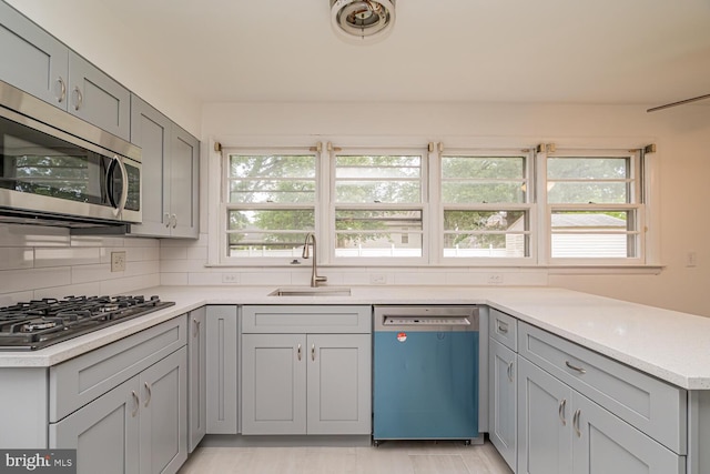 1916 Porter Ave, Suitland, MD 20746 - kitchen featuring stainless steel appliances, gray cabinets, light countertops, and backsplash