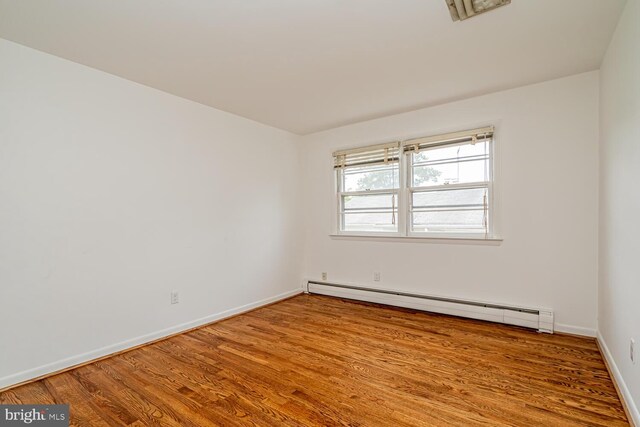 1916 Porter Ave, Suitland, MD 20746 - spare room with a baseboard heating unit and wood finished floors