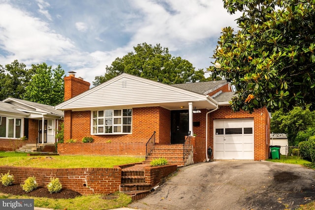 1916 Porter Ave, Suitland, MD 20746 - view of front of home with an attached garage, a chimney, asphalt driveway, brick siding, and a front yard