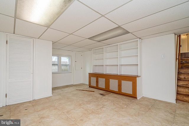 1916 Porter Ave, Suitland, MD 20746 - spare room featuring built in shelves, a drop ceiling, and stairs