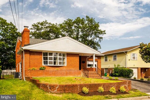 1916 Porter Ave, Suitland, MD 20746 - view of front facade featuring a chimney, brick siding, a front lawn, asphalt driveway, and an attached garage