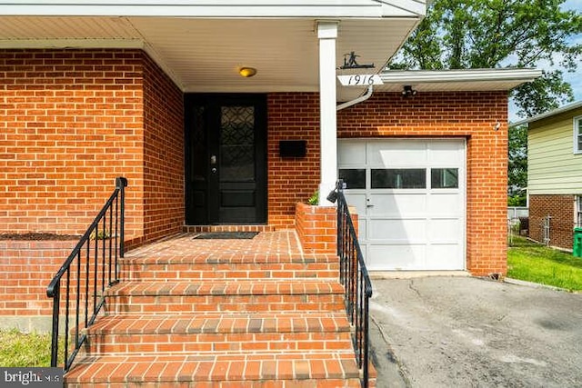 1916 Porter Ave, Suitland, MD 20746 - property entrance with brick siding, asphalt driveway, and a garage