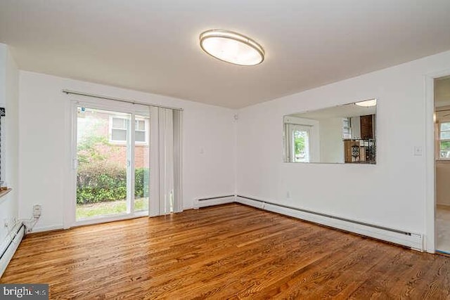 1916 Porter Ave, Suitland, MD 20746 - empty room with healthy amount of natural light, wood finished floors, and a baseboard radiator