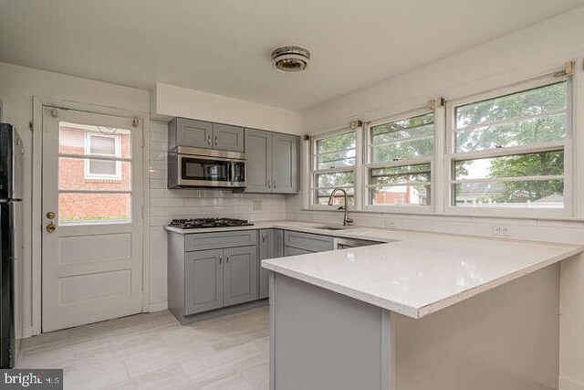 1916 Porter Ave, Suitland, MD 20746 - kitchen with gray cabinets, stainless steel microwave, gas stovetop, and a peninsula
