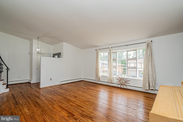 1916 Porter Ave, Suitland, MD 20746 - unfurnished living room with wood finished floors, stairs, lofted ceiling, and a baseboard radiator