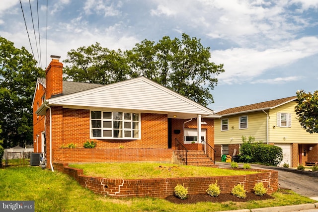 1916 Porter Ave, Suitland, MD 20746 - view of front of house featuring brick siding, a chimney, a front yard, and asphalt driveway