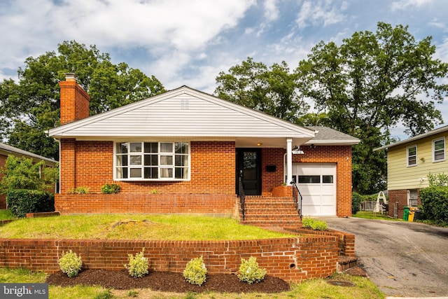 1916 Porter Ave, Suitland, MD 20746 - view of front of house with an attached garage, asphalt driveway, a chimney, brick siding, and a front lawn