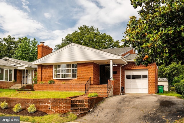 1916 Porter Ave, Suitland, MD 20746 - view of front of house featuring an attached garage, a chimney, driveway, brick siding, and a front lawn