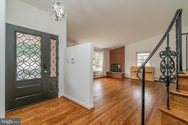 1916 Porter Ave, Suitland, MD 20746 - entryway featuring lofted ceiling, wood finished floors, a brick fireplace, and a baseboard radiator
