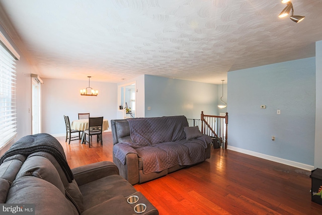 8935 Twin Ridge Dr, Glen Burnie, MD 21061 - living room with a chandelier, wood finished floors, and a textured ceiling