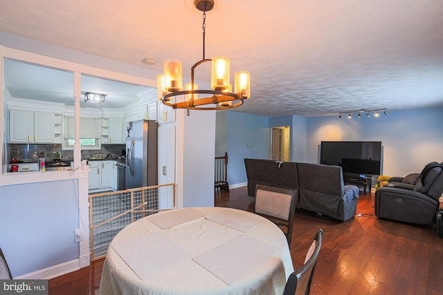 8935 Twin Ridge Dr, Glen Burnie, MD 21061 - dining room with a chandelier, dark wood-style flooring, and rail lighting