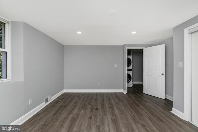 7702 Burnside Rd, Landover, MD 20785 - spare room featuring stacked washer and clothes dryer, dark wood finished floors, and recessed lighting