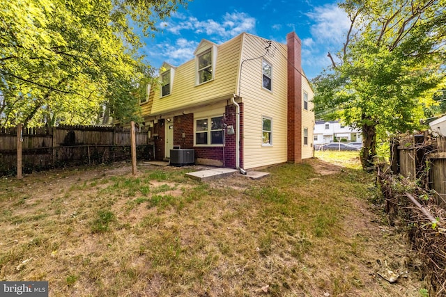 7702 Burnside Rd, Landover, MD 20785 - back of house featuring brick siding, a chimney, and a fenced backyard
