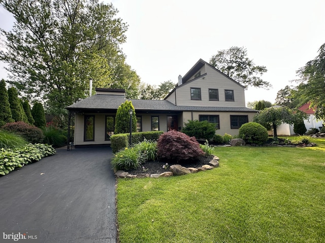 607 Cembra Ct, Feasterville Trevose, PA 19053 - view of front of property featuring a front lawn, a shingled roof, driveway, and a chimney