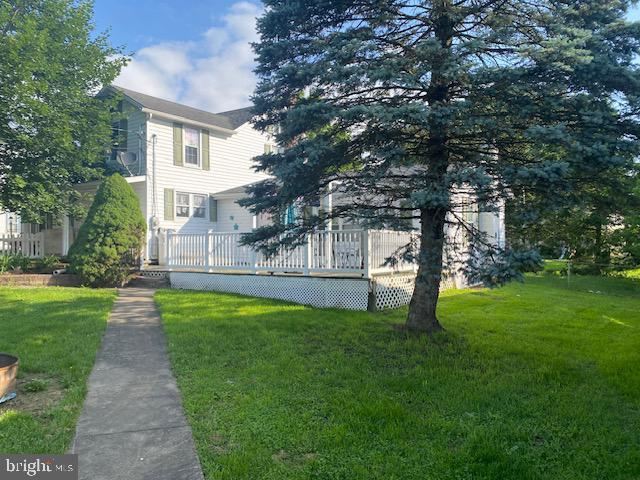 21 Willow St, Milroy, PA 17063 - view of front of home featuring a wooden deck and a front yard