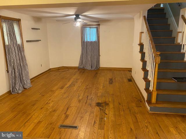 21 Willow St, Milroy, PA 17063 - unfurnished room with a ceiling fan, hardwood / wood-style floors, and stairs
