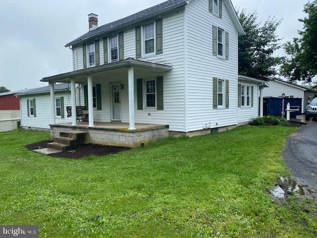 21 Willow St, Milroy, PA 17063 - view of front facade featuring covered porch, a front lawn, and a chimney