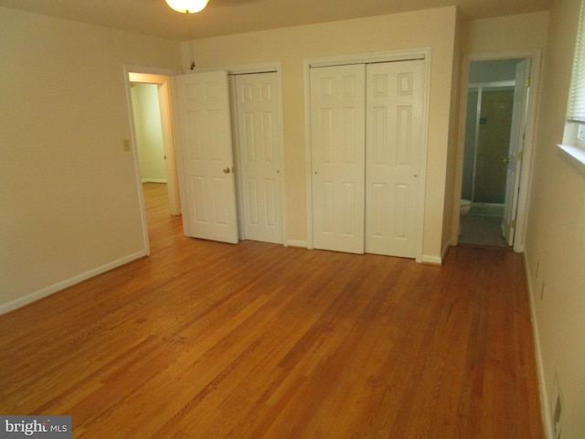 5606 Devon Ct, Temple Hills, MD 20748 - unfurnished bedroom with multiple closets and light wood-style flooring