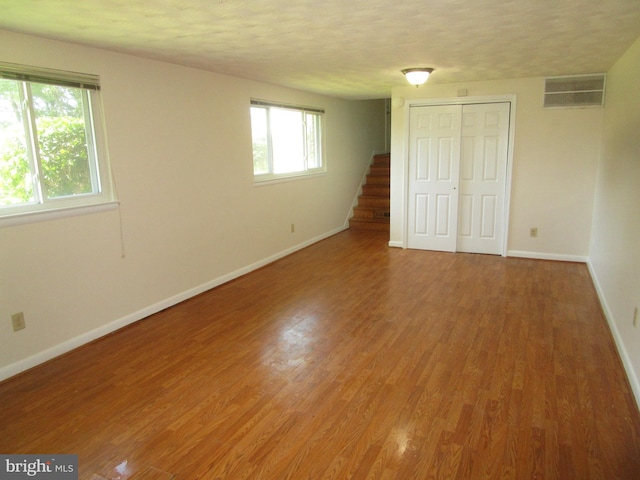 5606 Devon Ct, Temple Hills, MD 20748 - unfurnished bedroom featuring a closet, wood finished floors, and a textured ceiling