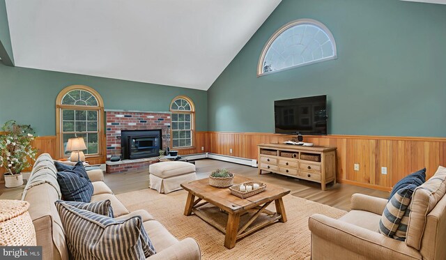 132 Sycamore Dr, Palmerton, PA 18071 - living area with a wainscoted wall, high vaulted ceiling, wood finished floors, baseboard heating, and a baseboard radiator