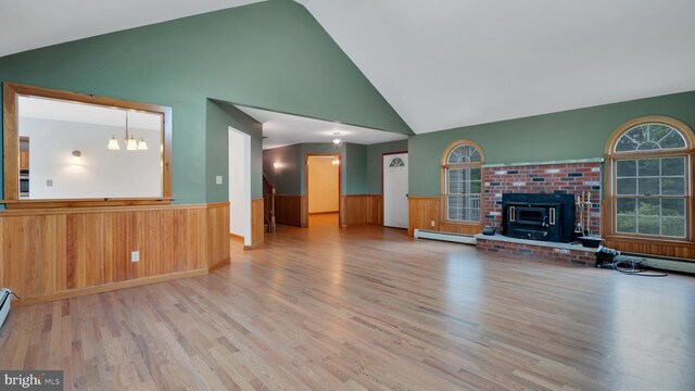 132 Sycamore Dr, Palmerton, PA 18071 - unfurnished living room featuring wainscoting, high vaulted ceiling, wood finished floors, a baseboard heating unit, and a chandelier