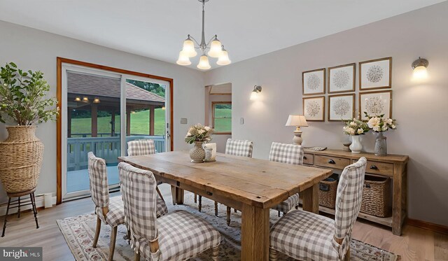 132 Sycamore Dr, Palmerton, PA 18071 - dining area with a chandelier, light wood finished floors, and a baseboard radiator