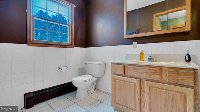 132 Sycamore Dr, Palmerton, PA 18071 - bathroom with tile walls, vanity, tile patterned floors, baseboard heating, and a wainscoted wall