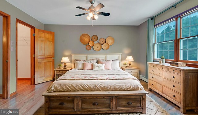 132 Sycamore Dr, Palmerton, PA 18071 - bedroom with wood finished floors, a baseboard radiator, and ceiling fan