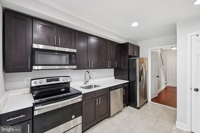 9046 Queen Maria Ct, Columbia, MD 21045 - kitchen with appliances with stainless steel finishes, light countertops, recessed lighting, dark brown cabinets, and light tile patterned floors