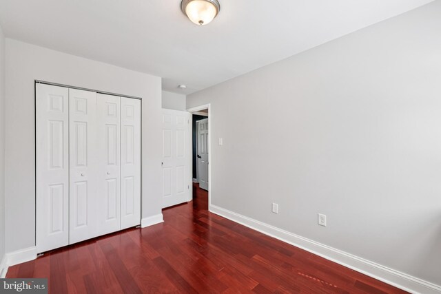 9046 Queen Maria Ct, Columbia, MD 21045 - unfurnished bedroom featuring wood finished floors and a closet