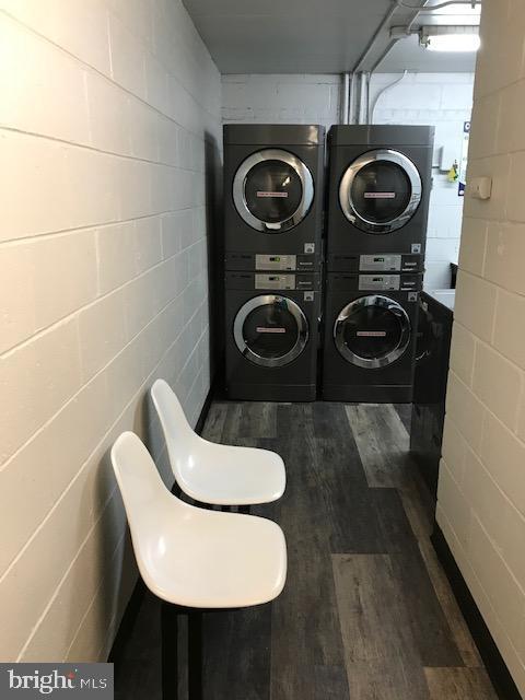 401 Cooper Landing Rd Unit 207Playa, Del Sol, Cherry Hill, NJ 08002 - laundry room featuring stacked washer / drying machine and dark wood-type flooring