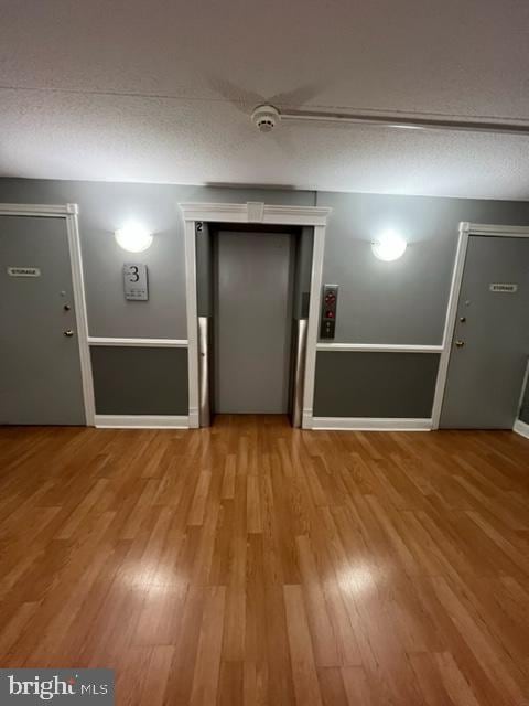 401 Cooper Landing Rd Unit 207Playa, Del Sol, Cherry Hill, NJ 08002 - spare room with elevator, wood finished floors, and a smoke detector