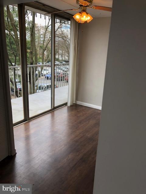 401 Cooper Landing Rd Unit 207Playa, Del Sol, Cherry Hill, NJ 08002 - spare room featuring dark wood finished floors, expansive windows, and ceiling fan