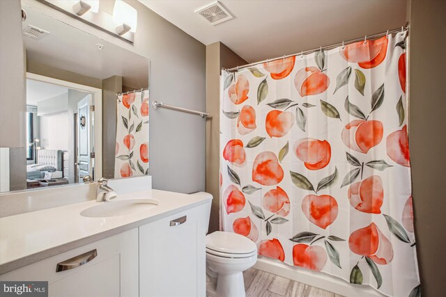 2451 Midtown Ave Unit 1323, Alexandria, VA 22303 - bathroom featuring vanity, wood finished floors, and curtained shower