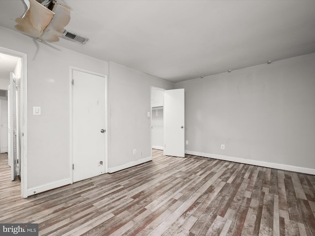 3316 Huntley Square Dr Unit A1, Temple Hills, MD 20748 - unfurnished bedroom with wood finished floors and a walk in closet