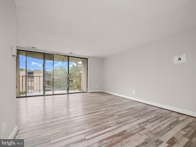 3316 Huntley Square Dr Unit A1, Temple Hills, MD 20748 - unfurnished room with a wall of windows and wood finished floors