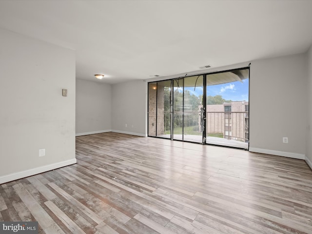 3316 Huntley Square Dr Unit A1, Temple Hills, MD 20748 - unfurnished room with a wall of windows and wood finished floors