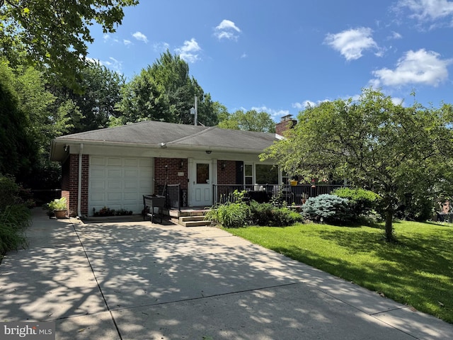 766 Clearmount Rd, York, PA 17403 - view of front of home featuring brick siding, driveway, a garage, a front yard, and a chimney