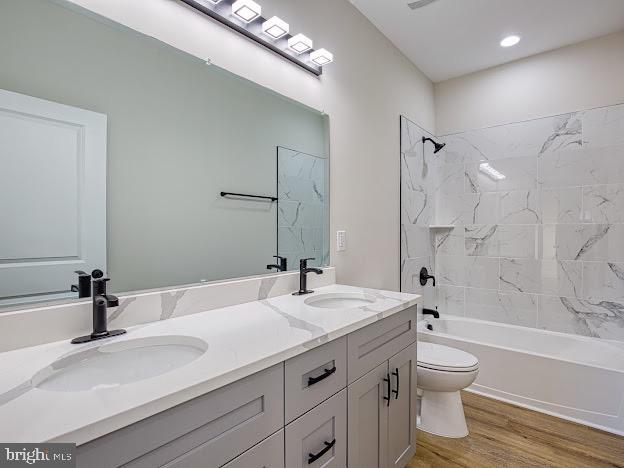 103 Woodland Dr, Montross, VA 22520 - full bath featuring double vanity, shower / tub combination, and wood finished floors