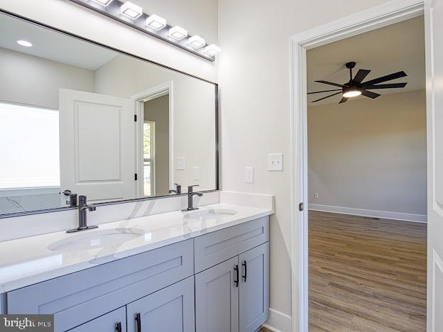103 Woodland Dr, Montross, VA 22520 - full bathroom with double vanity, ceiling fan, and wood finished floors
