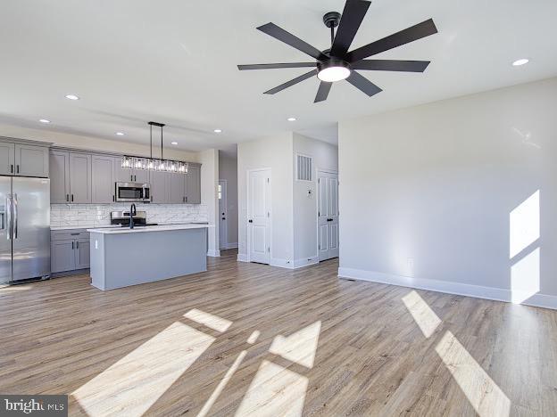103 Woodland Dr, Montross, VA 22520 - kitchen featuring stainless steel appliances, gray cabinets, open floor plan, and recessed lighting