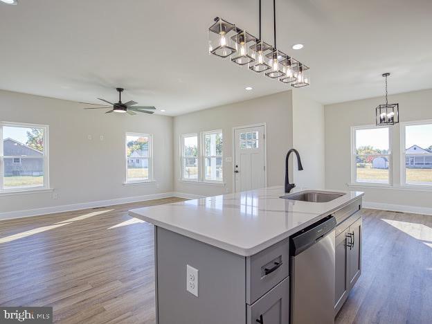 103 Woodland Dr, Montross, VA 22520 - kitchen with dishwasher, wood finished floors, light countertops, a center island with sink, and a ceiling fan