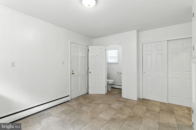 312 Wellington, Reading, PA 19609 - unfurnished bedroom with a baseboard heating unit, a closet, stone finish floors, and ensuite bath