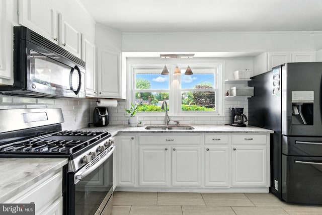 312 Wellington, Reading, PA 19609 - kitchen featuring stainless steel appliances, tasteful backsplash, white cabinets, and light stone countertops