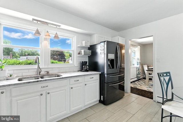312 Wellington, Reading, PA 19609 - kitchen with fridge with ice dispenser, white cabinetry, backsplash, and light stone counters
