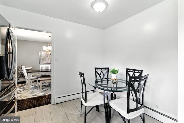 312 Wellington, Reading, PA 19609 - dining space featuring a baseboard heating unit and a chandelier