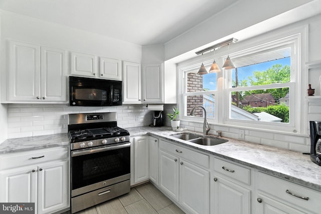 312 Wellington, Reading, PA 19609 - kitchen featuring stainless steel gas stove, black microwave, and white cabinets